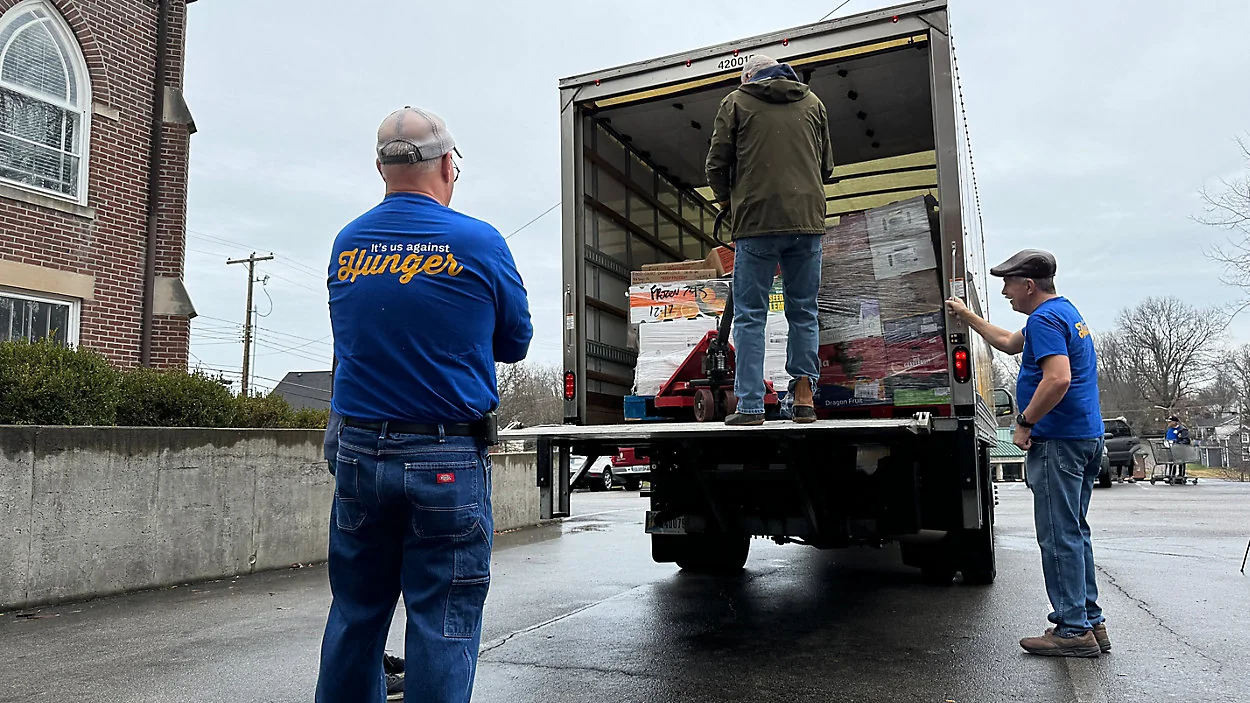 AMEN House volunteers unloading food donations