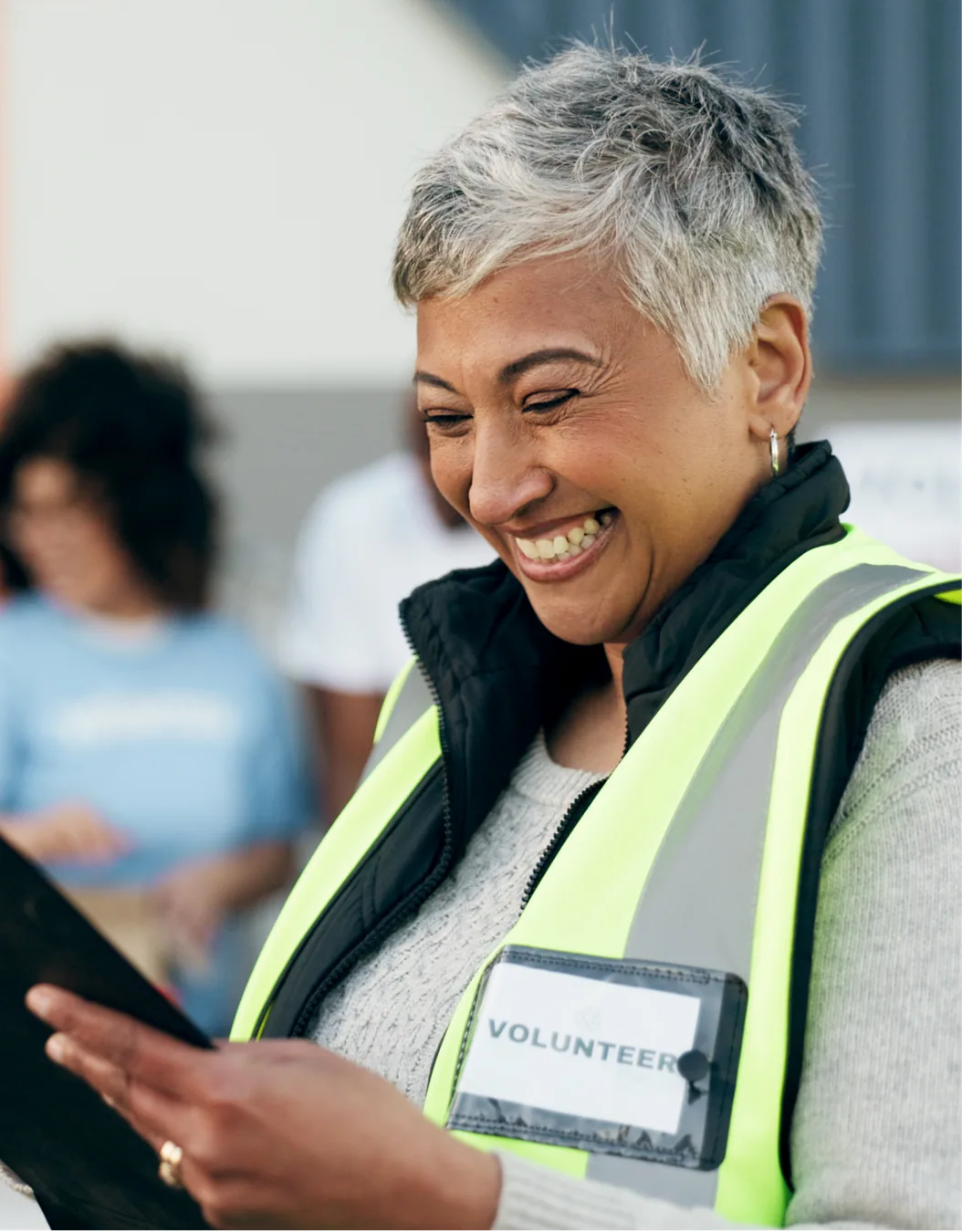 A nonprofit volunteer reviewing information on a tablet